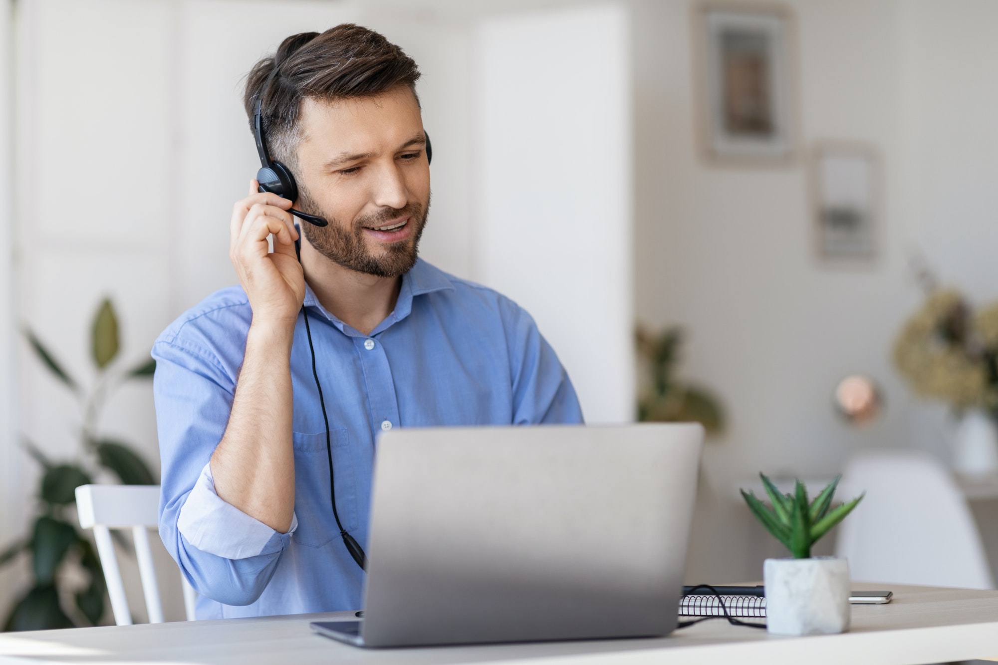 hotline-operator-portrait-of-call-center-employee-wearing-headset-at-workplace-in-office.jpg